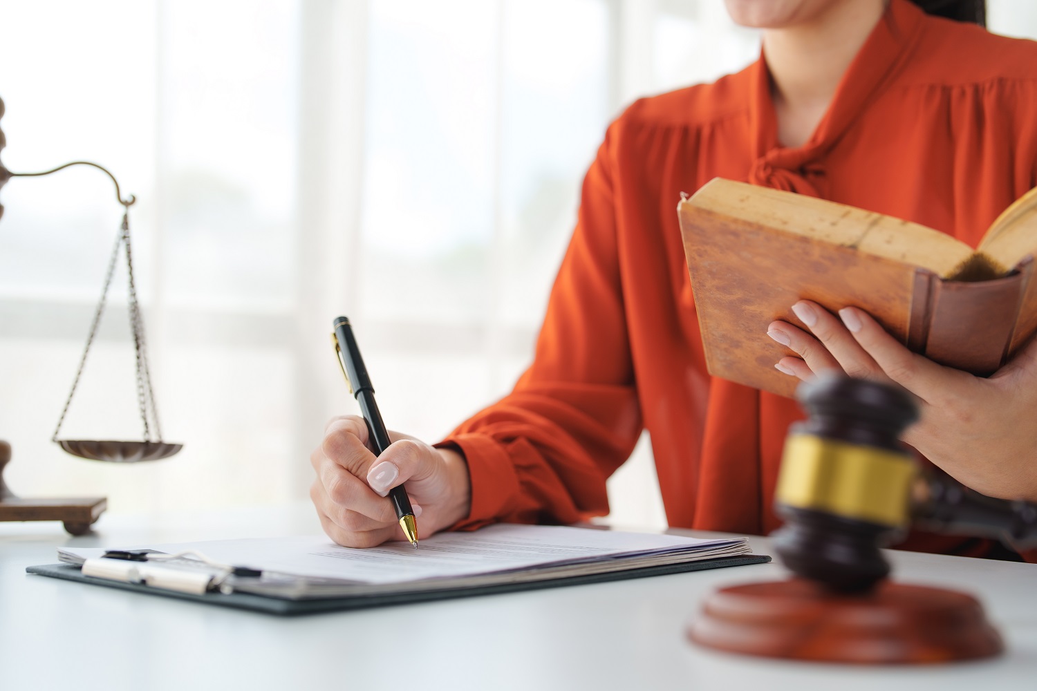 Woman taking notes from book
