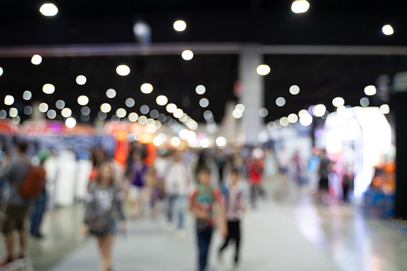 a blurred image of a crowd at an expo