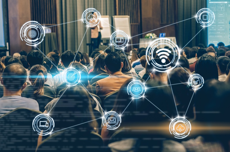 People watching presentation with icons overlayed to denote technology