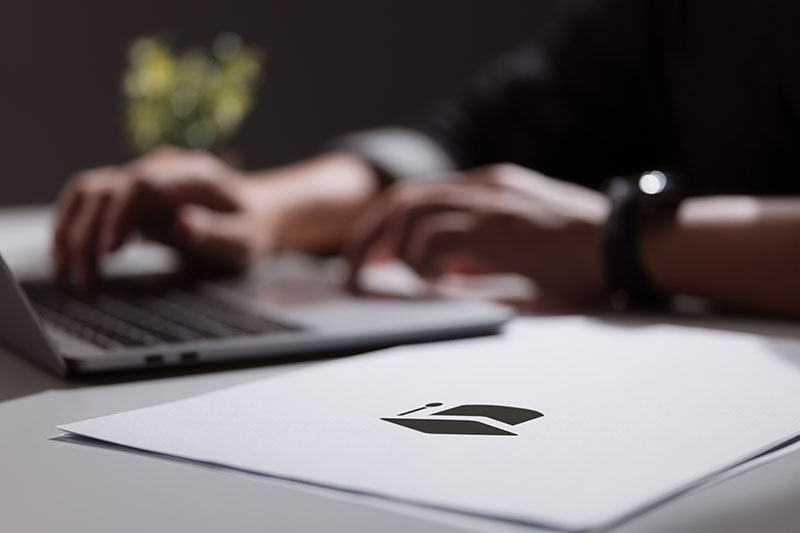 Hands typing on a laptop keyboard